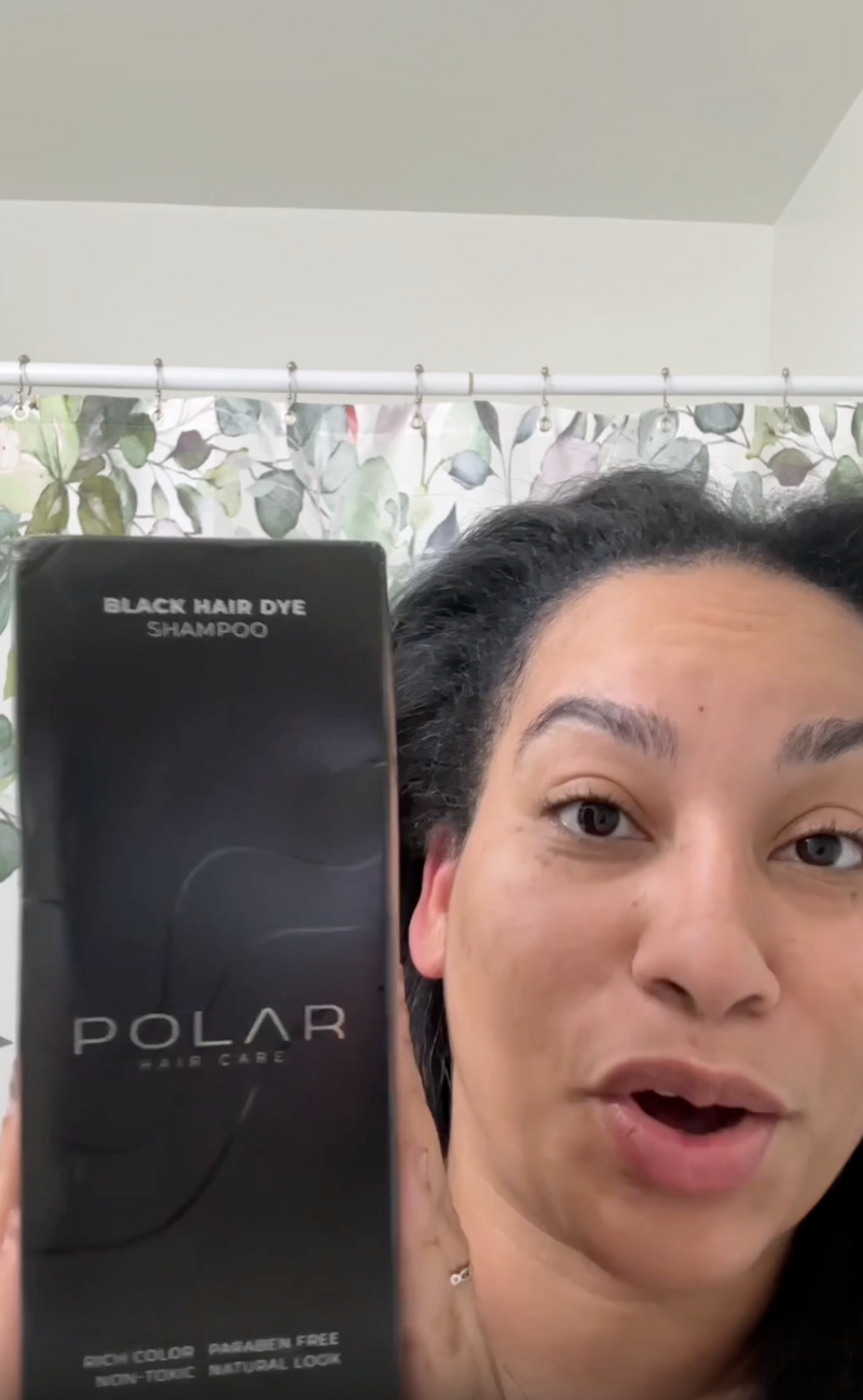 Person holding a box of Polar Black Hair Dye Shampoo